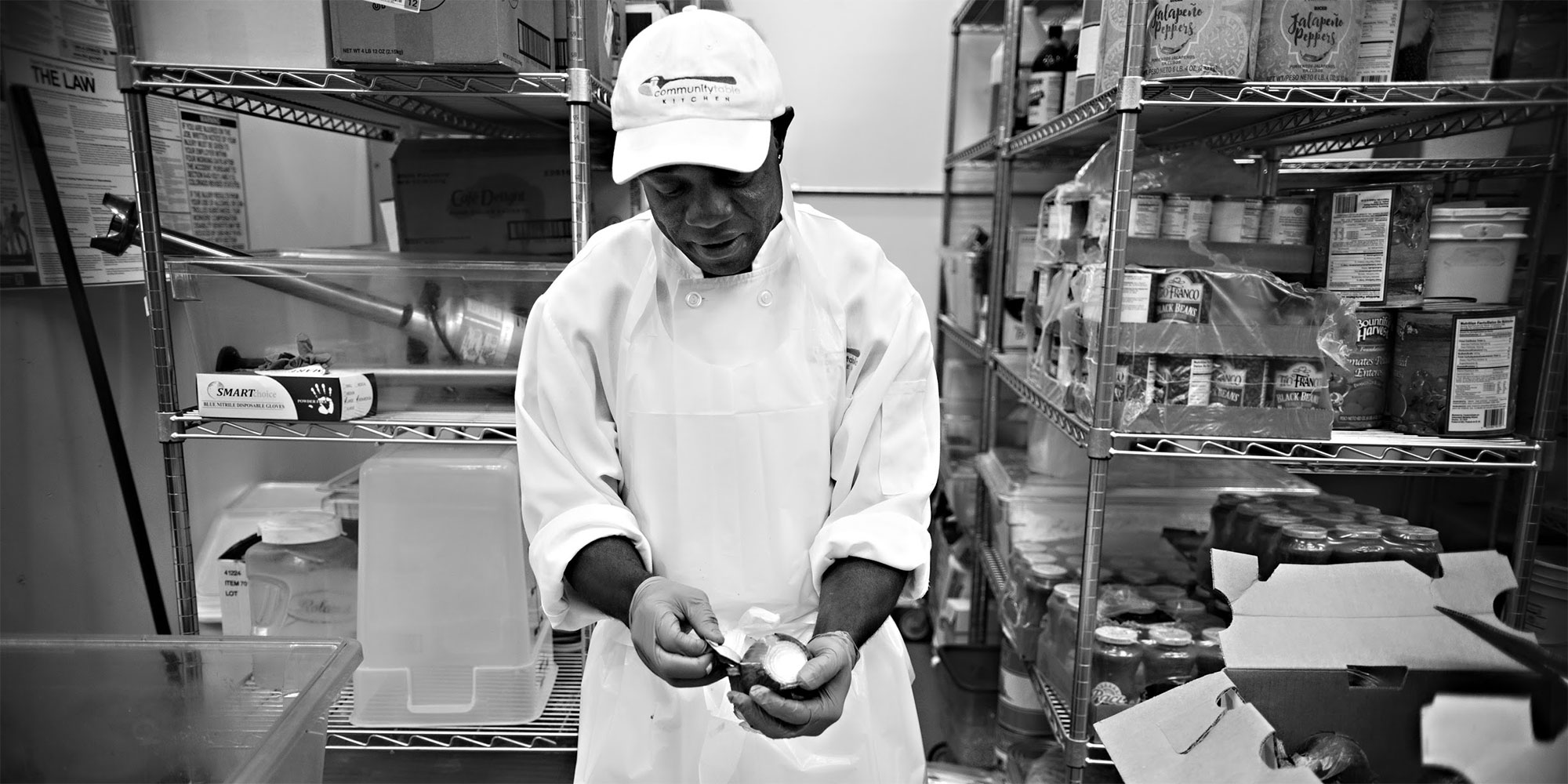 A man preps food in a commercial kitchen